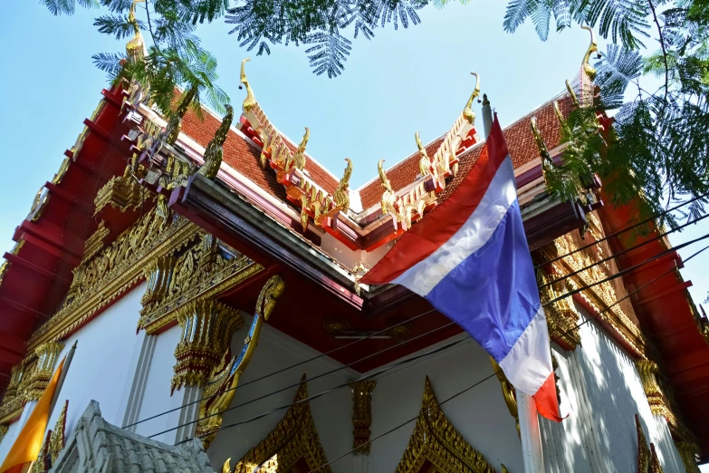 an ornate building with flags hanging from it
