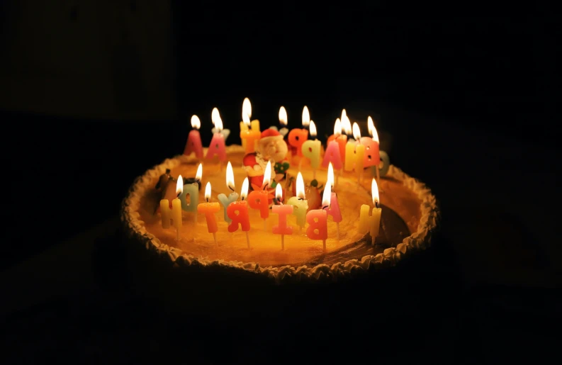 an individual birthday cake with candles in it