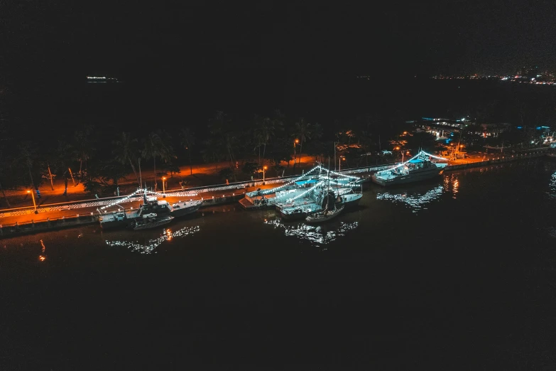 a marina with lit up boats at night