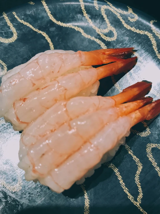 three shrimp fill the plate with shrimp