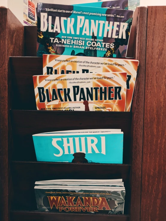 a wooden book shelf filled with magazines