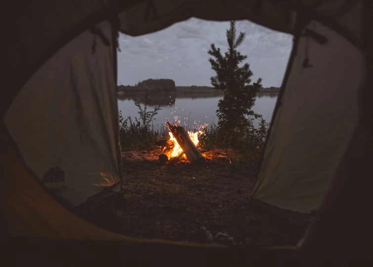 view from inside of tent of camp fire