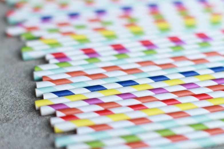 several different colored straws lined up and laid out