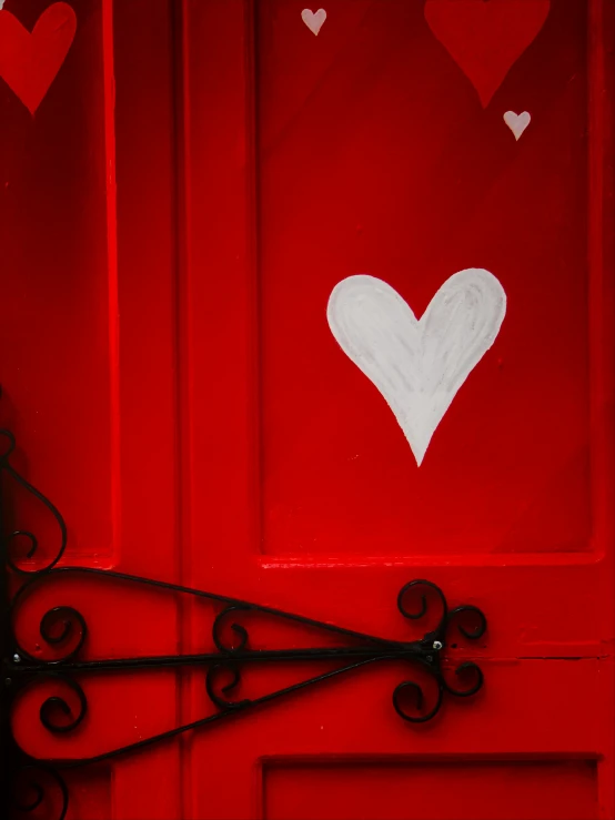 a close up of a door with some hearts painted on it