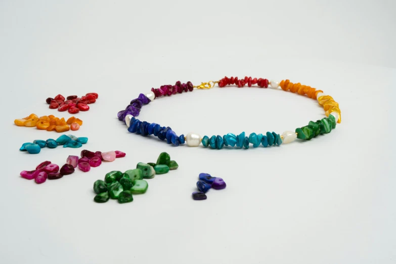 a variety of multi - colored beads are being arranged in a circle