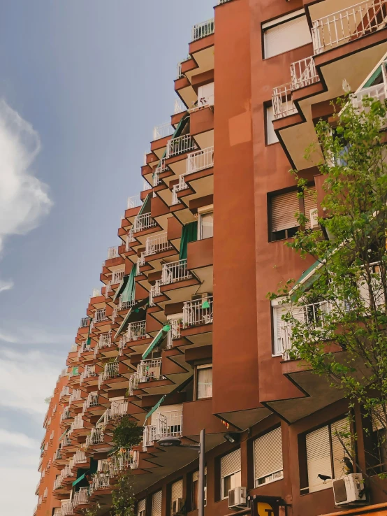 a tall building with balconies against a blue sky