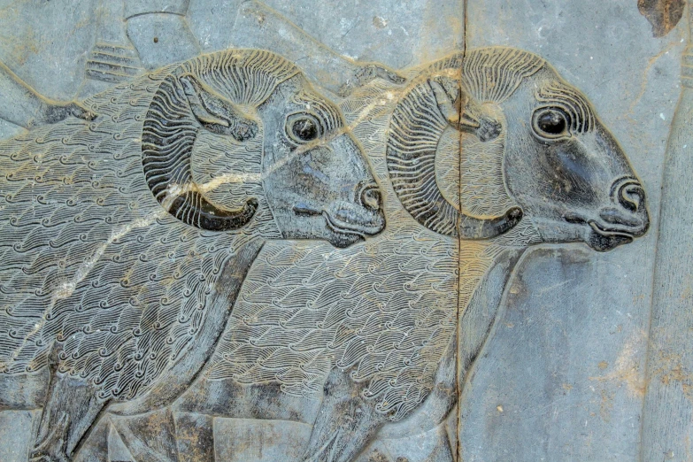 a stone wall with animals carved in it