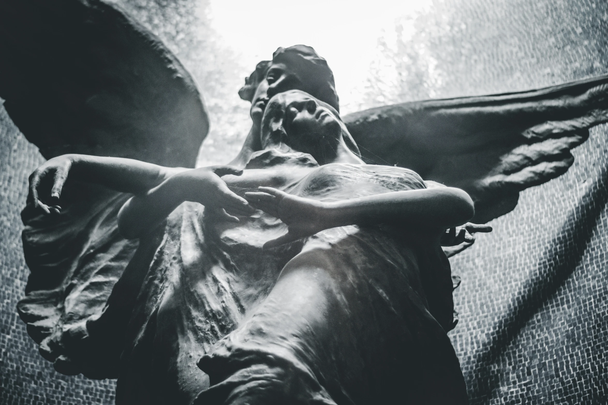 an angel statue laying on its side with it's wings spread