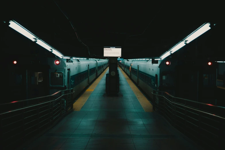 an empty subway train station with a person at the entrance