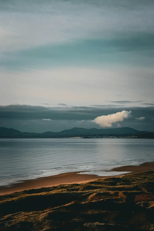 the clouds are hanging low over the ocean