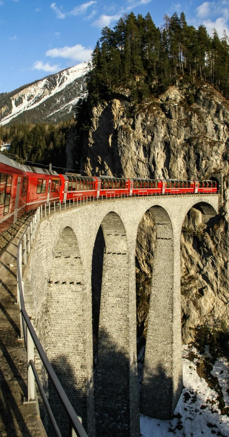 a train that is on the tracks going across the bridge