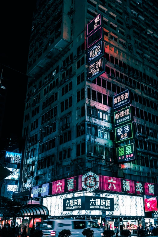 large skyscr at night lit up with neon signs