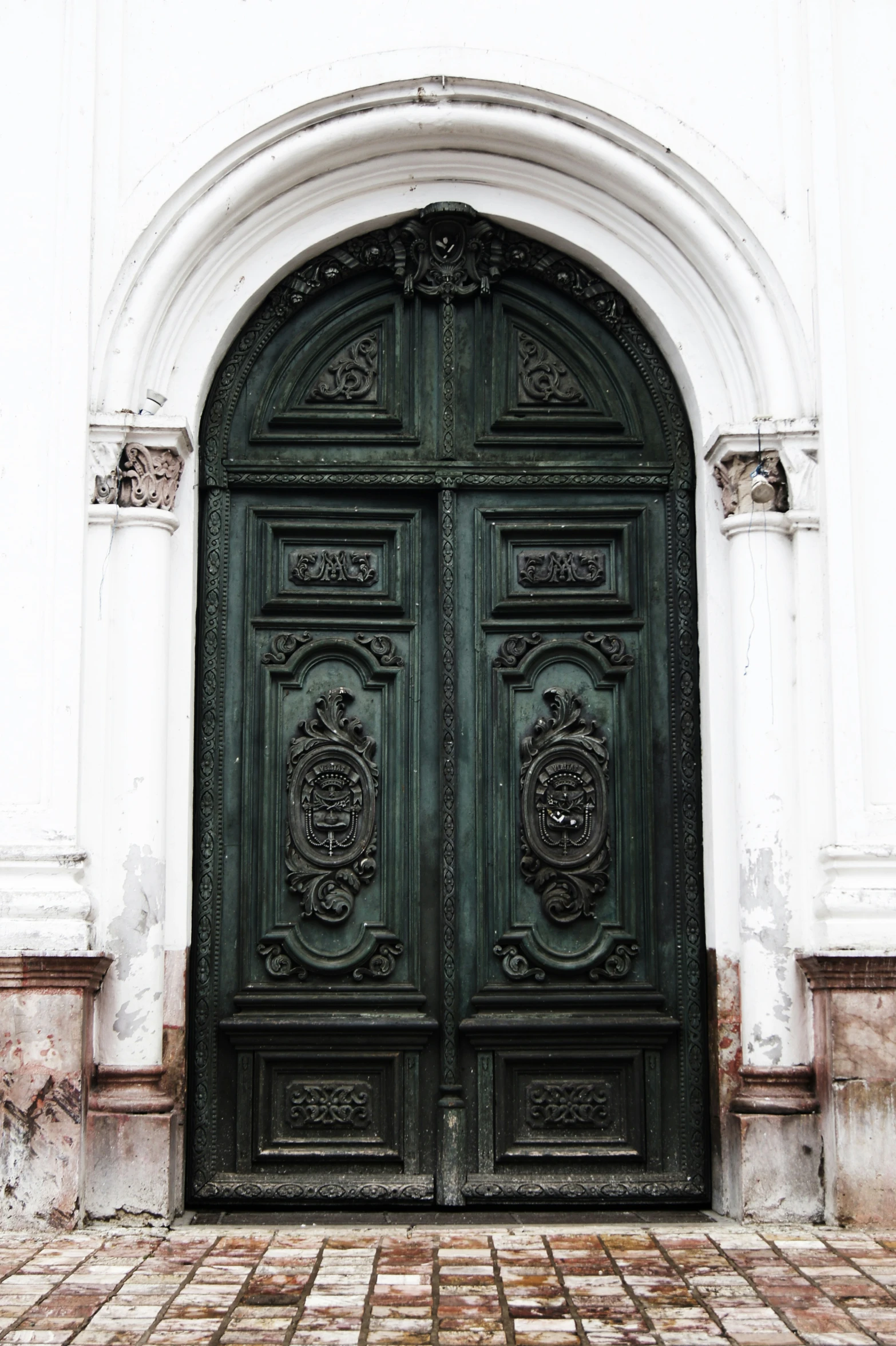 a dark door with a light green door handle