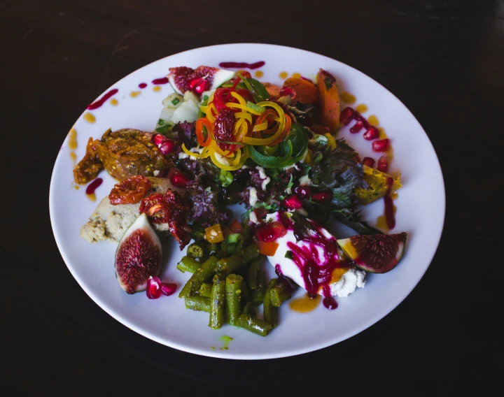 a plate of food containing vegetables on the side