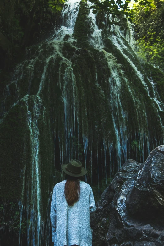 person standing at edge of water cascadings