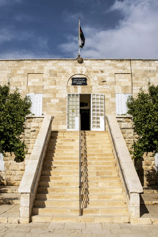 the steps lead up to a building with many windows