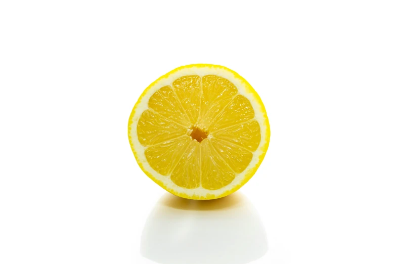 the half - eaten lemon is placed next to a piece of fruit