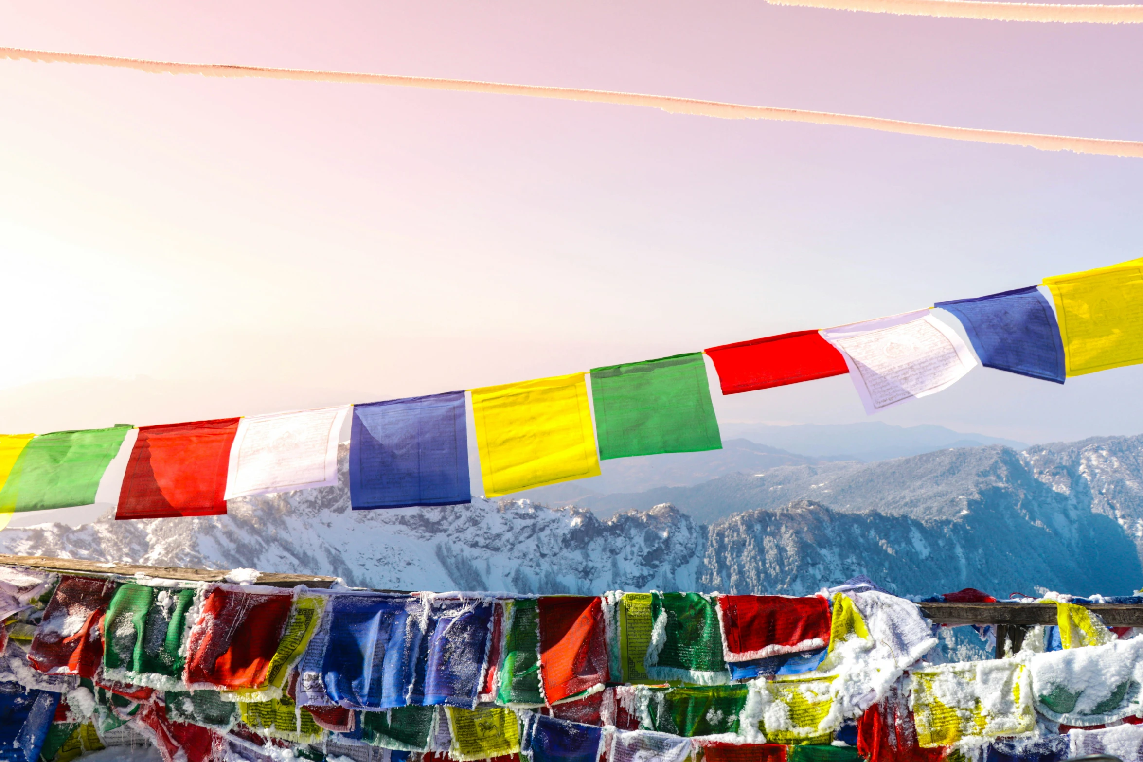 colorful flags are shown against the backdrop of a mountain