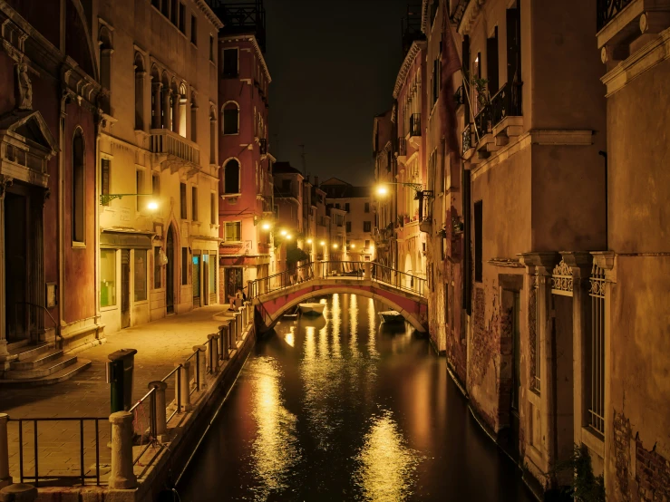 a canal flows under a bridge in a town