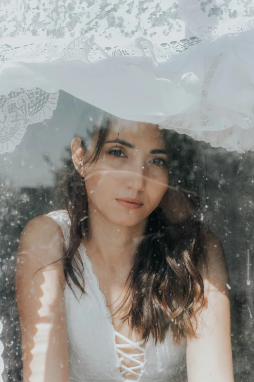 a woman that is holding an umbrella with her face