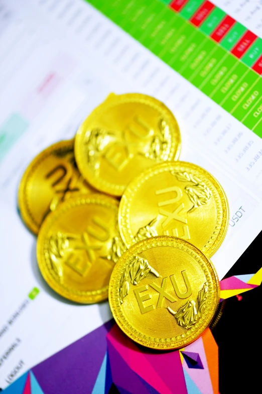 a group of golden coin sitting next to an info sheet