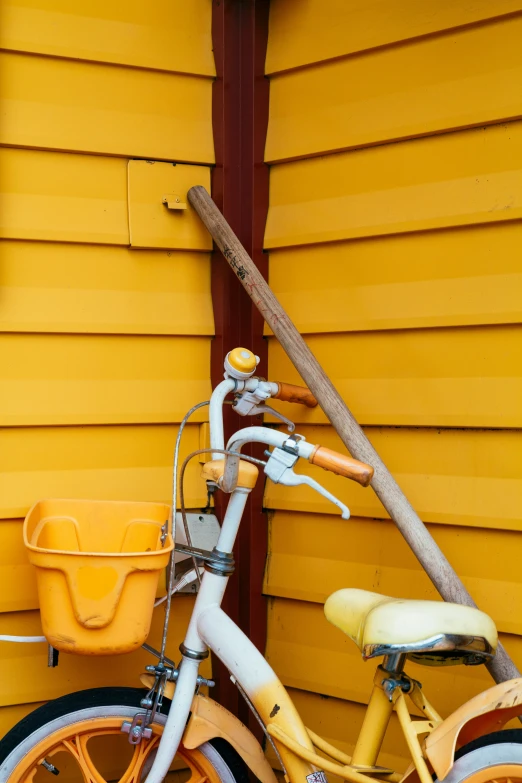 an orange bicycle parked in front of a building