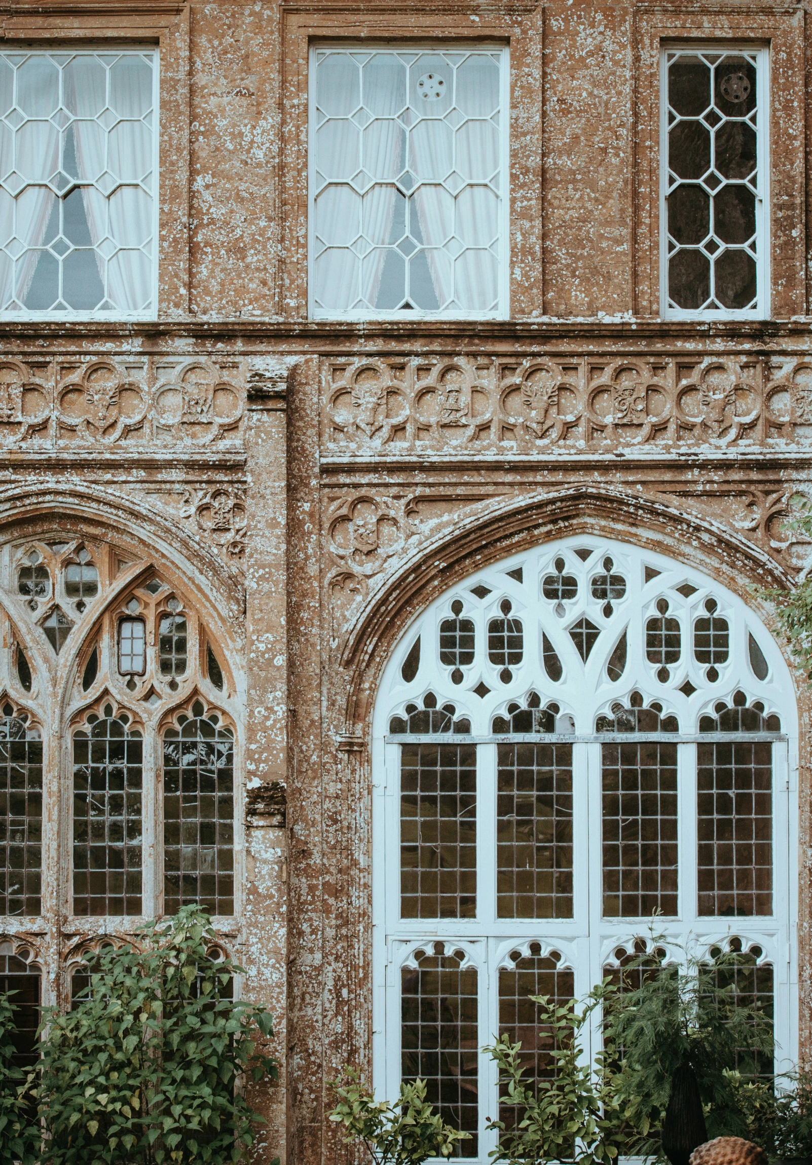 a brick building has multiple windows and a clock on the side