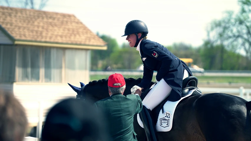 an equestrian jumps their horse in the middle of a race