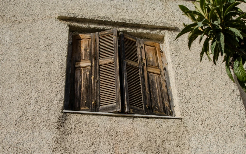 two open shutters on an old building