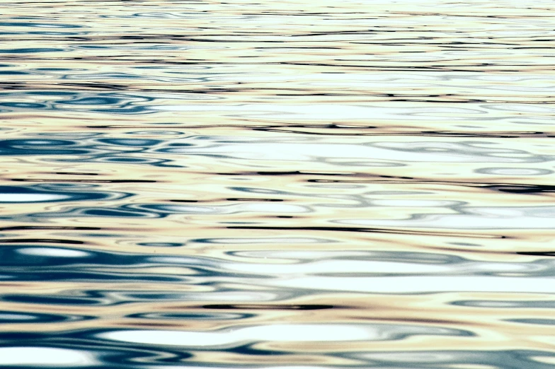 abstract pograph of rippled water in the sun