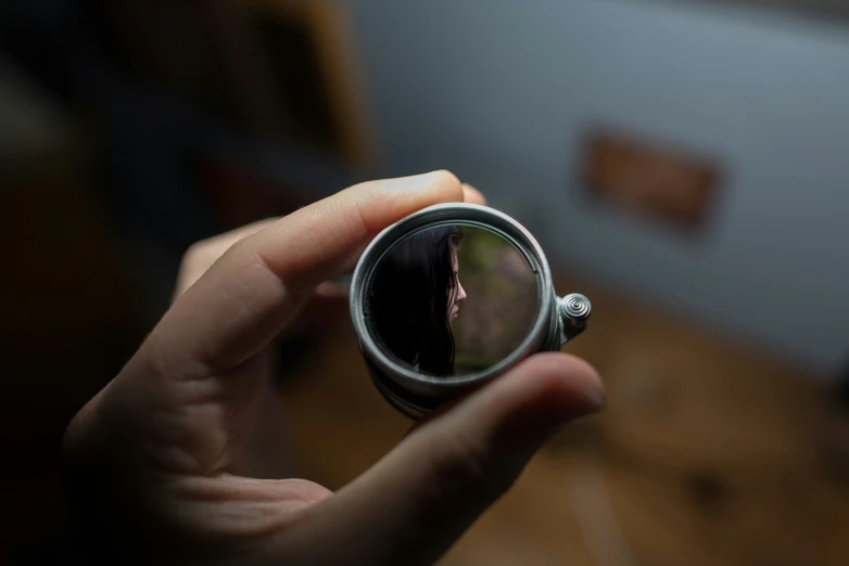 the reflection of a lady's face in a magnifying glass