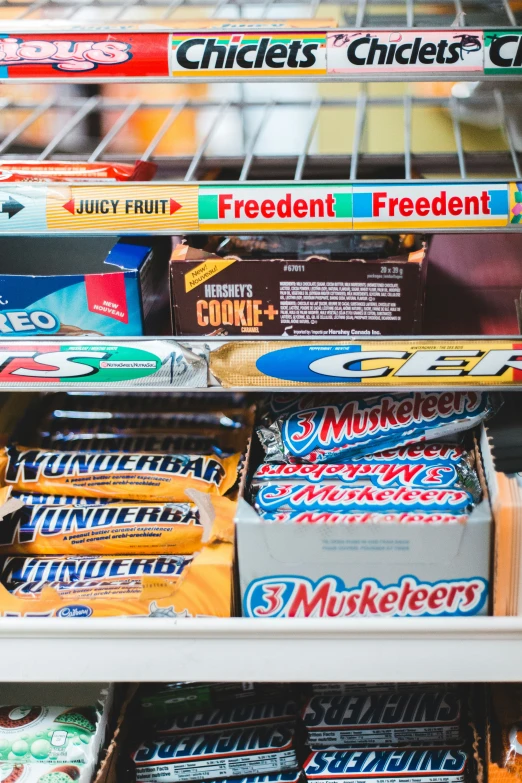 a display in a supermarket with a fridge full of snacks and bars