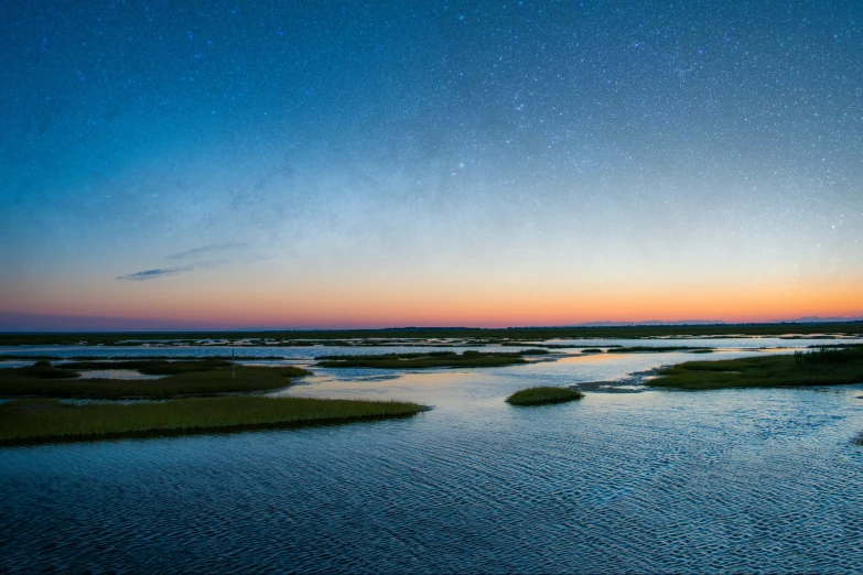 an image of a twilight with stars over a lake