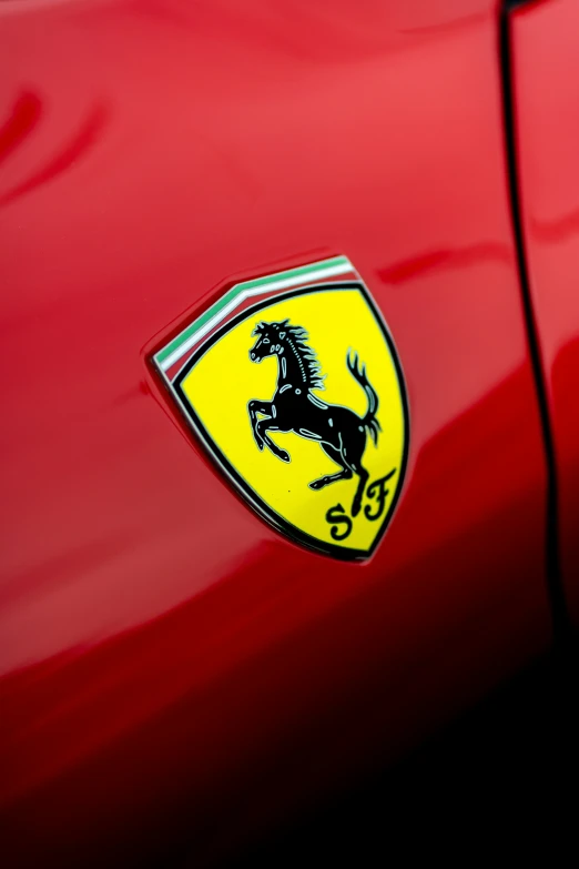 the emblem on the front of a red car