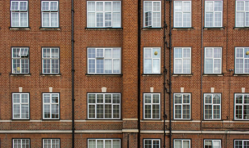 a very tall brown brick building with lots of windows