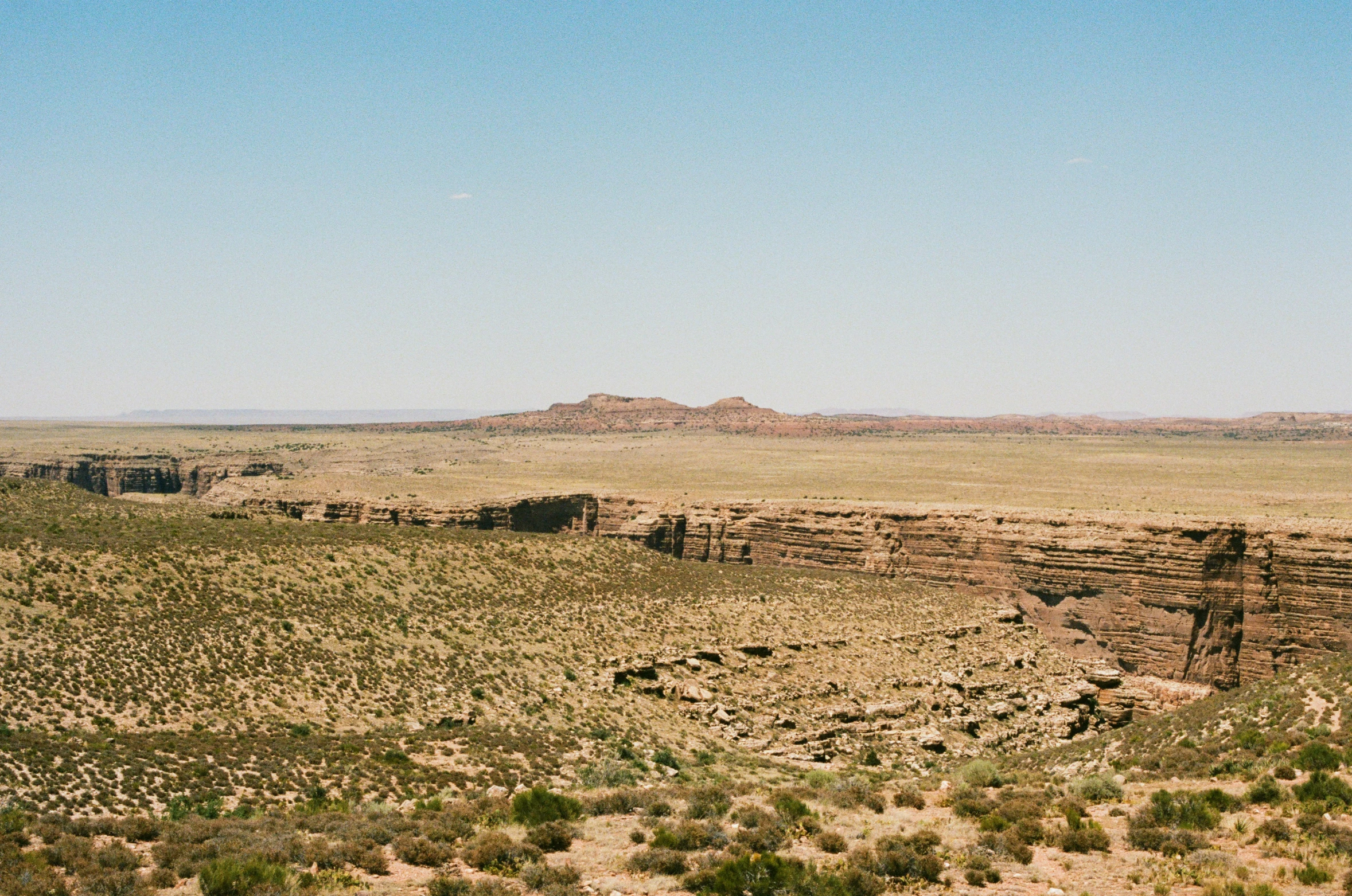 there is a small desert with large rocks and bushes