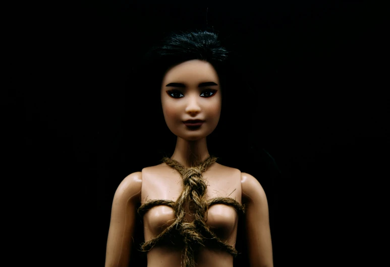 an unusual fashion doll dressed in gold accessories