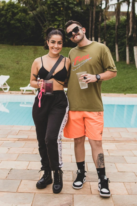 the woman stands beside the man posing next to her