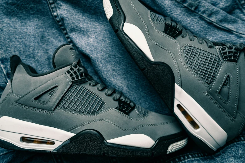 the air jordan 4's is seen on a man's jeans