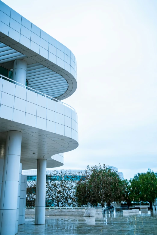 a building with a spiral pattern and a couple of people standing outside