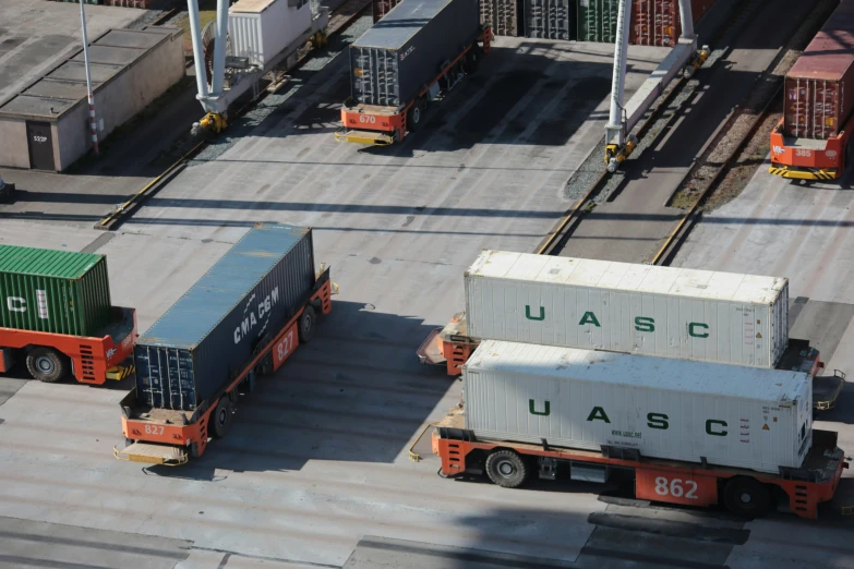 three truck loading freight from one semi and a truck