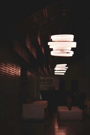 there are many lights hanging over a room