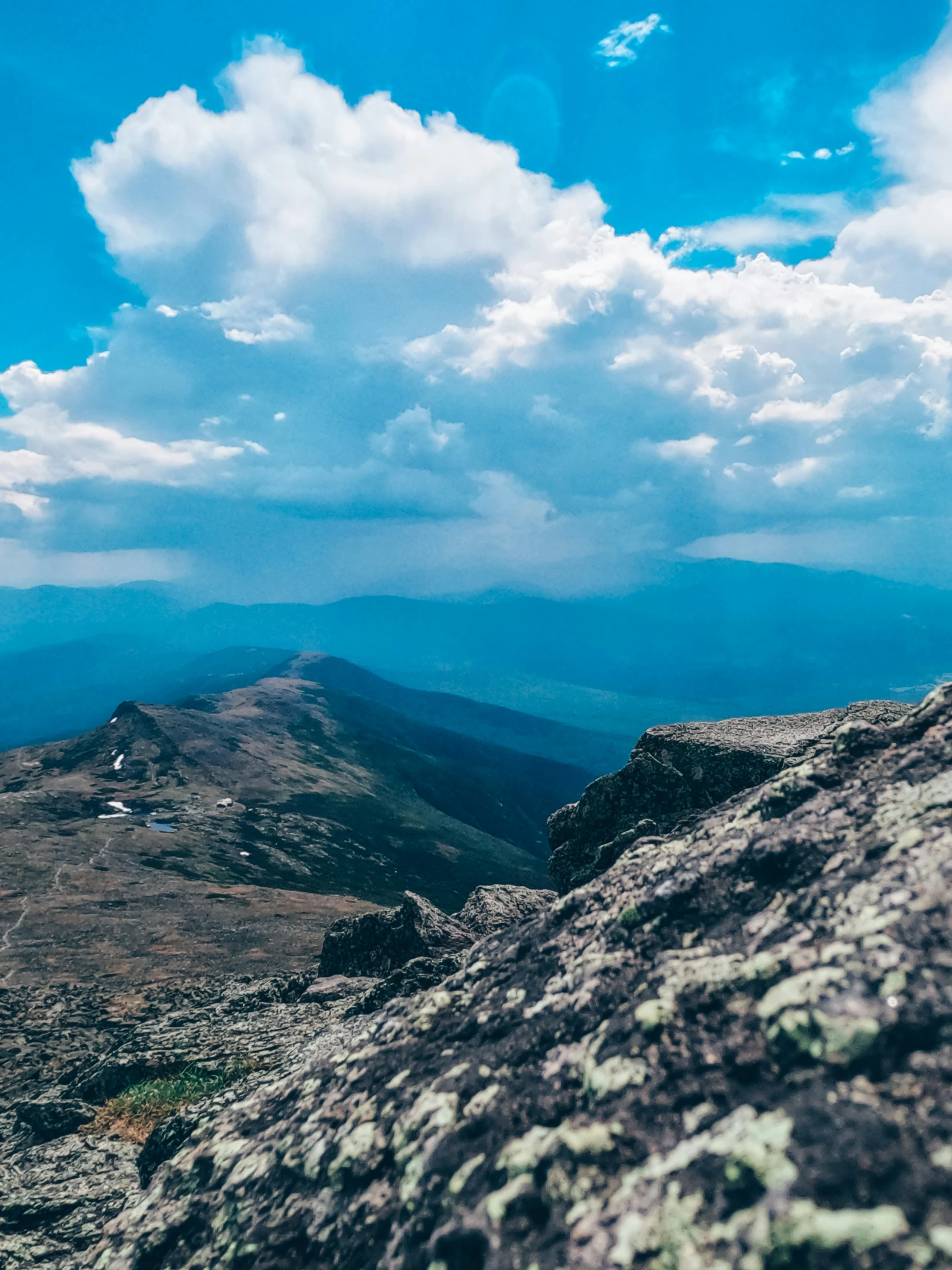 two rocks near the top of a mountain