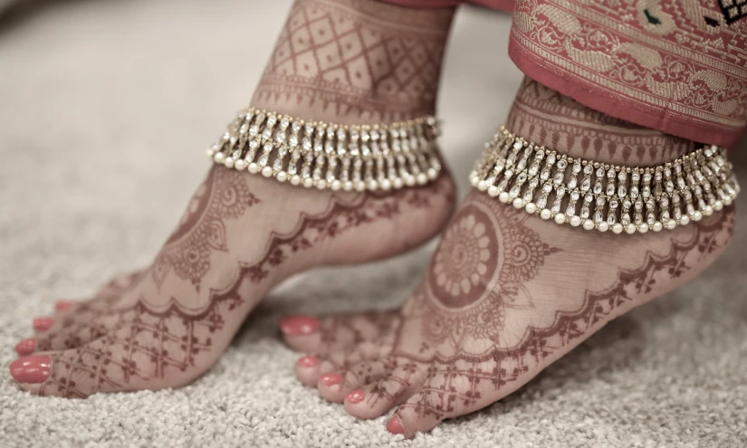 the brides legs and ankles have beads and chains on them