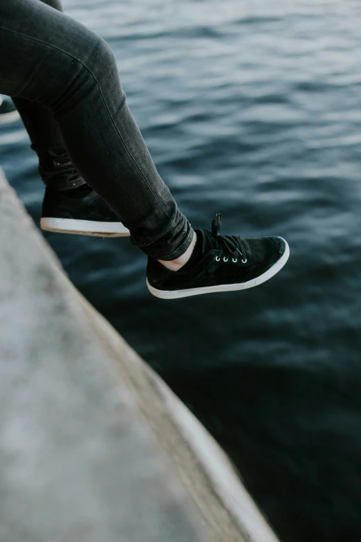 a person sitting in a bench near water