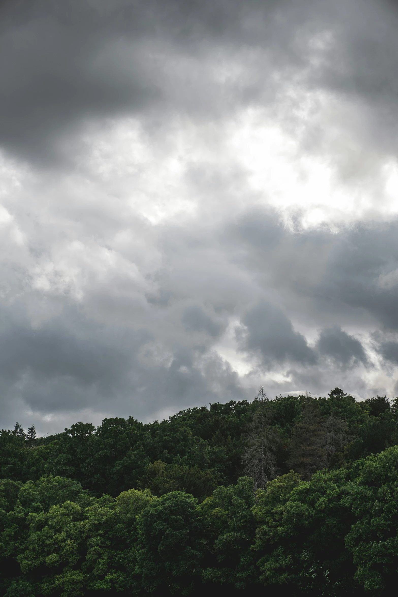 two airplanes flying in front of a dark and cloudy sky