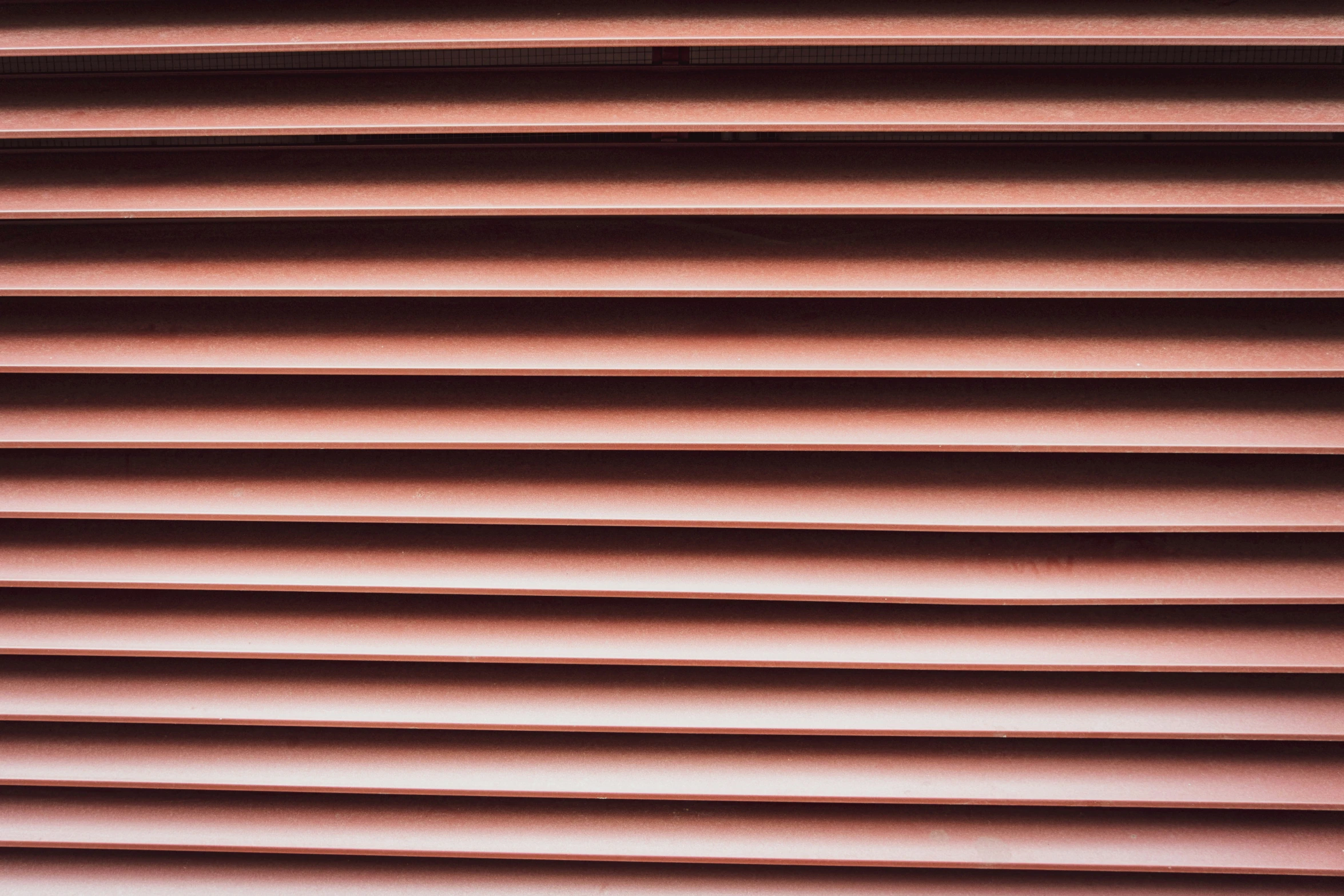 close up of the horizontal window shades of a window