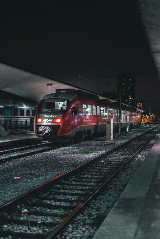 a train is coming up the tracks at night