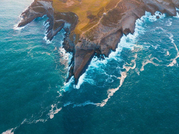 an island surrounded by the ocean with a single wave