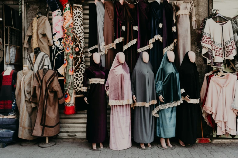 a few women standing in front of clothes